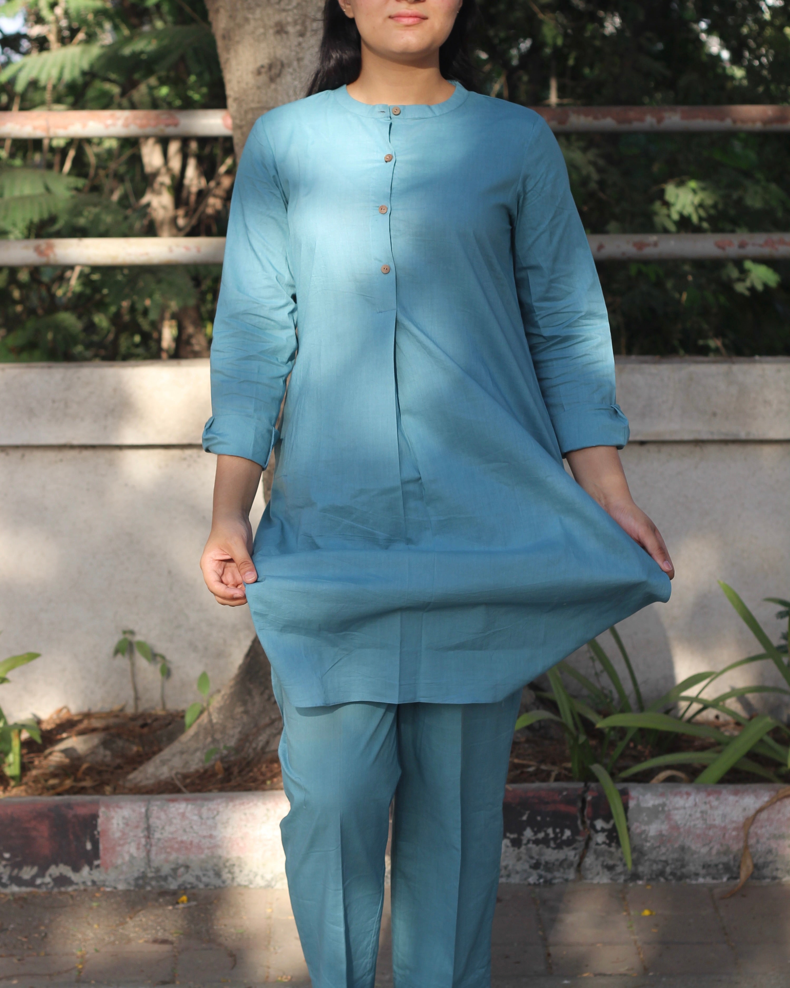 Pure Cambric Cotton Powder Blue Co-ord set featuring a long kurta with round side cuts and brown neck buttons, paired with soft and comfortable pants, ideal for versatile summer wear