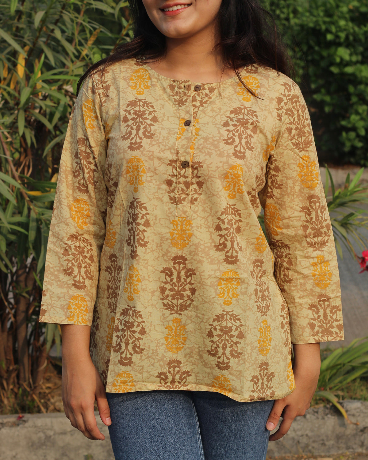 Ochre yellow cotton short kurta with round neck and brown buttons