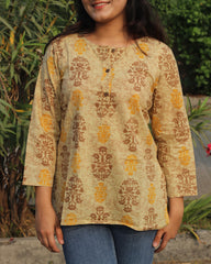 Ochre yellow cotton short kurta with round neck and brown buttons