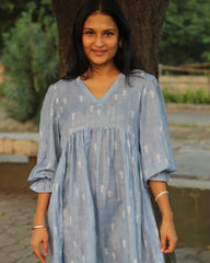 Blue stripes cotton linen dress in Alia cut with puff 3/4 sleeves and white motifs all over, showcasing our best-selling print