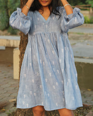 Blue stripes cotton linen dress in Alia cut with puff 3/4 sleeves and white motifs all over, showcasing our best-selling print