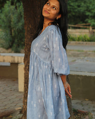 Blue stripes cotton linen dress in Alia cut with puff 3/4 sleeves and white motifs all over, showcasing our best-selling print