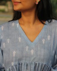 Blue stripes cotton linen dress in Alia cut with puff 3/4 sleeves and white motifs all over, showcasing our best-selling print