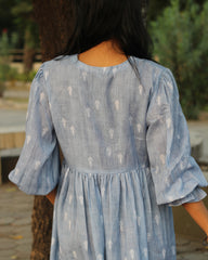 Blue stripes cotton linen dress in Alia cut with puff 3/4 sleeves and white motifs all over, showcasing our best-selling print