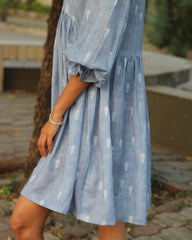 Blue stripes cotton linen dress in Alia cut with puff 3/4 sleeves and white motifs all over, showcasing our best-selling print