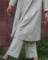 Beige handloom cotton kurta set with stripe pattern, side detail pockets, relaxed neck, and box 3/4 sleeves, paired with elastic waist pants