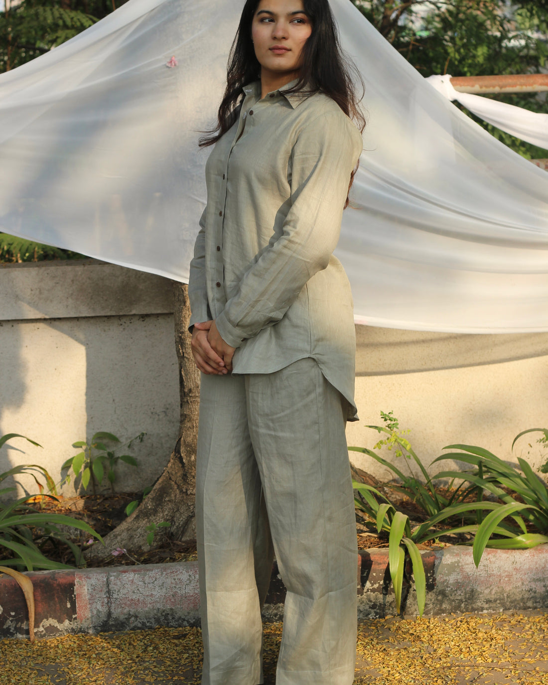 Sustainable fashion in action with a model showcasing a linen attire in a natural, sage green hue, ideal for eco-conscious individuals