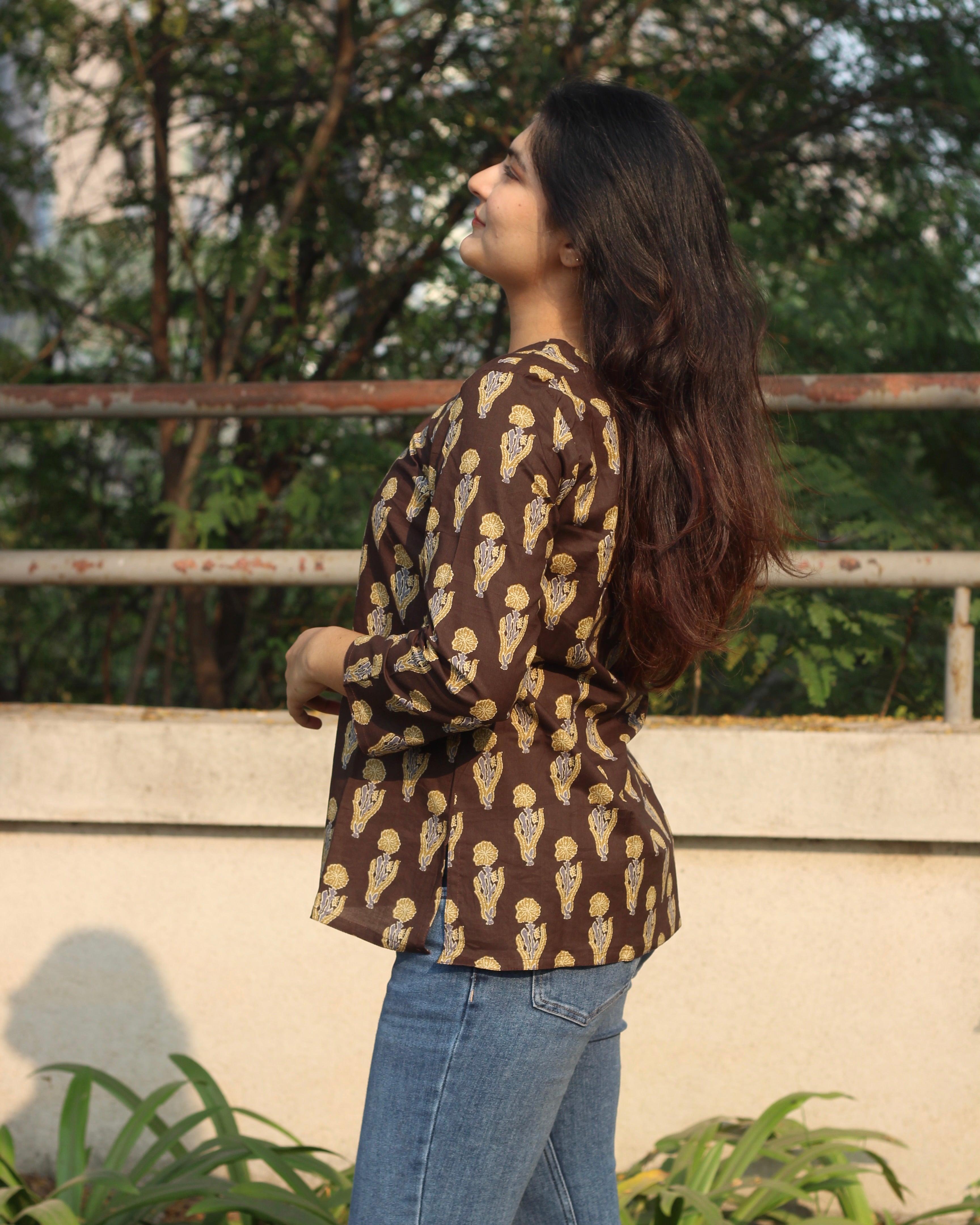 Comfortable brown printed short kurta with contrasting booti, ideal for casual outings or work wear, featuring 3/4 sleeves and a round neck.