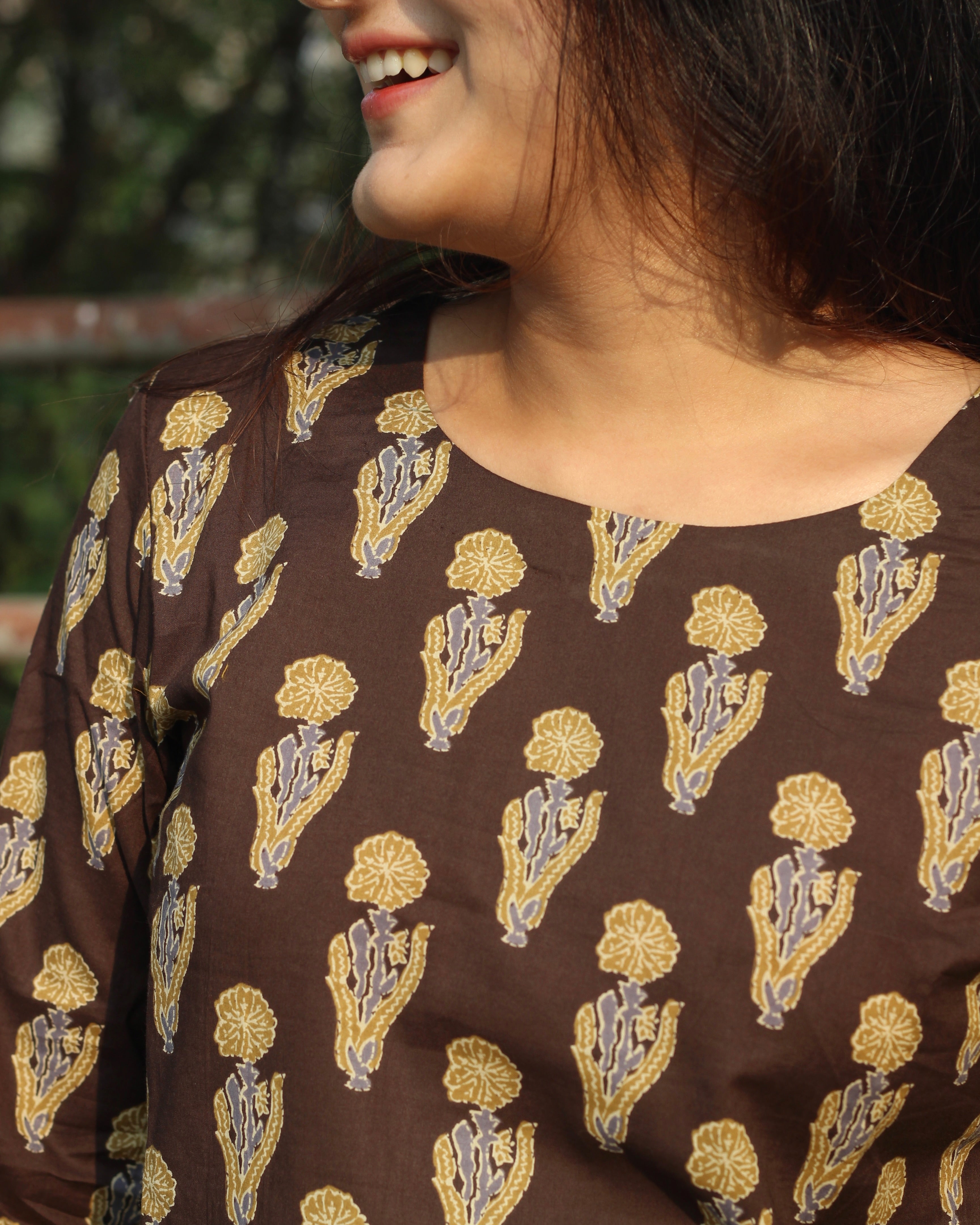 Comfortable brown printed short kurta with contrasting booti, ideal for casual outings or work wear, featuring 3/4 sleeves and a round neck