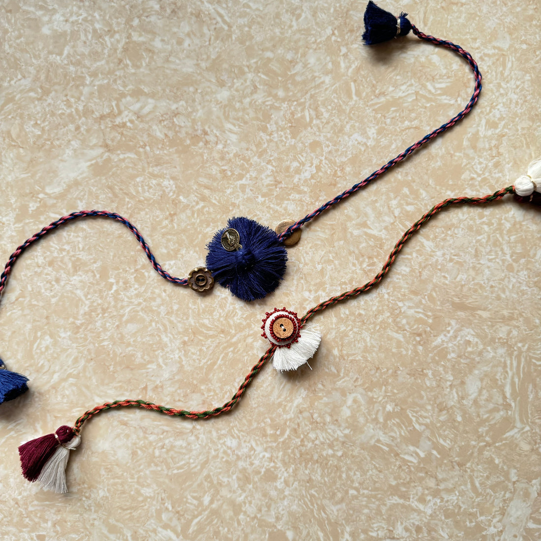 Set of 2 Rakhis - Blue tassel & Button maroon handwork rakhi