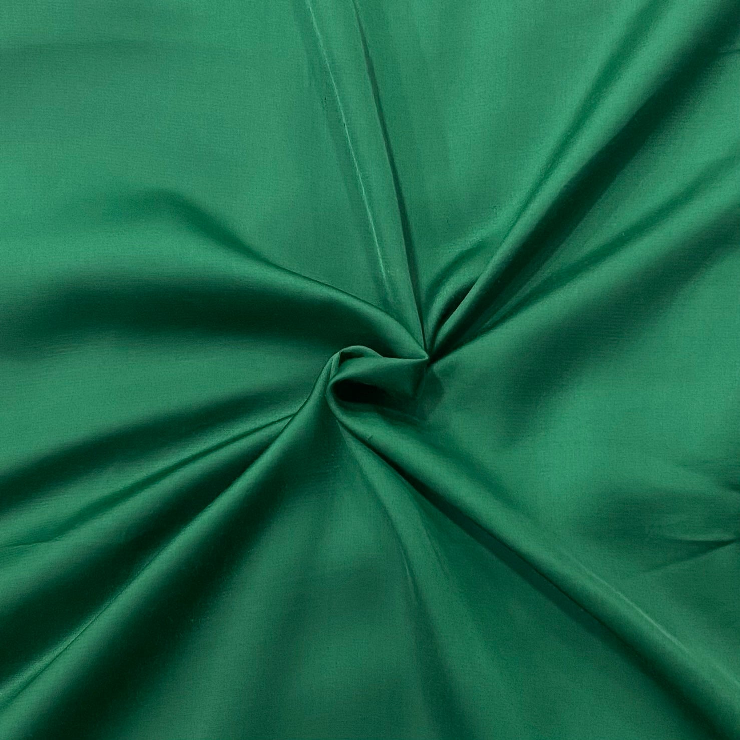 Detail shot of Lush Green Modal Satin's glossy surface, showcasing the luxurious sheen