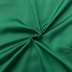 Detail shot of Lush Green Modal Satin's glossy surface, showcasing the luxurious sheen