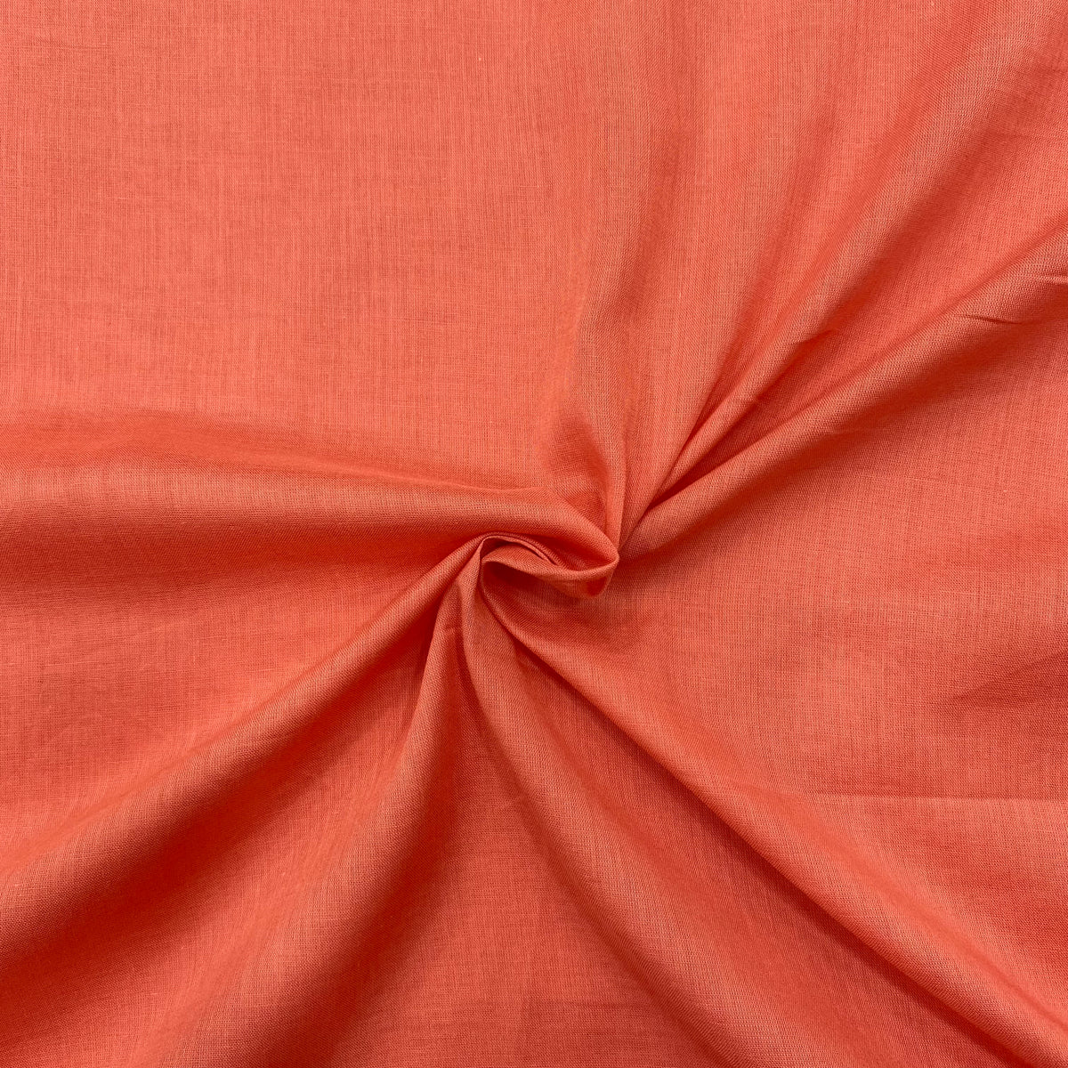 Image of light rust orange mul cotton fabric, soft and breathable, perfect for summer 