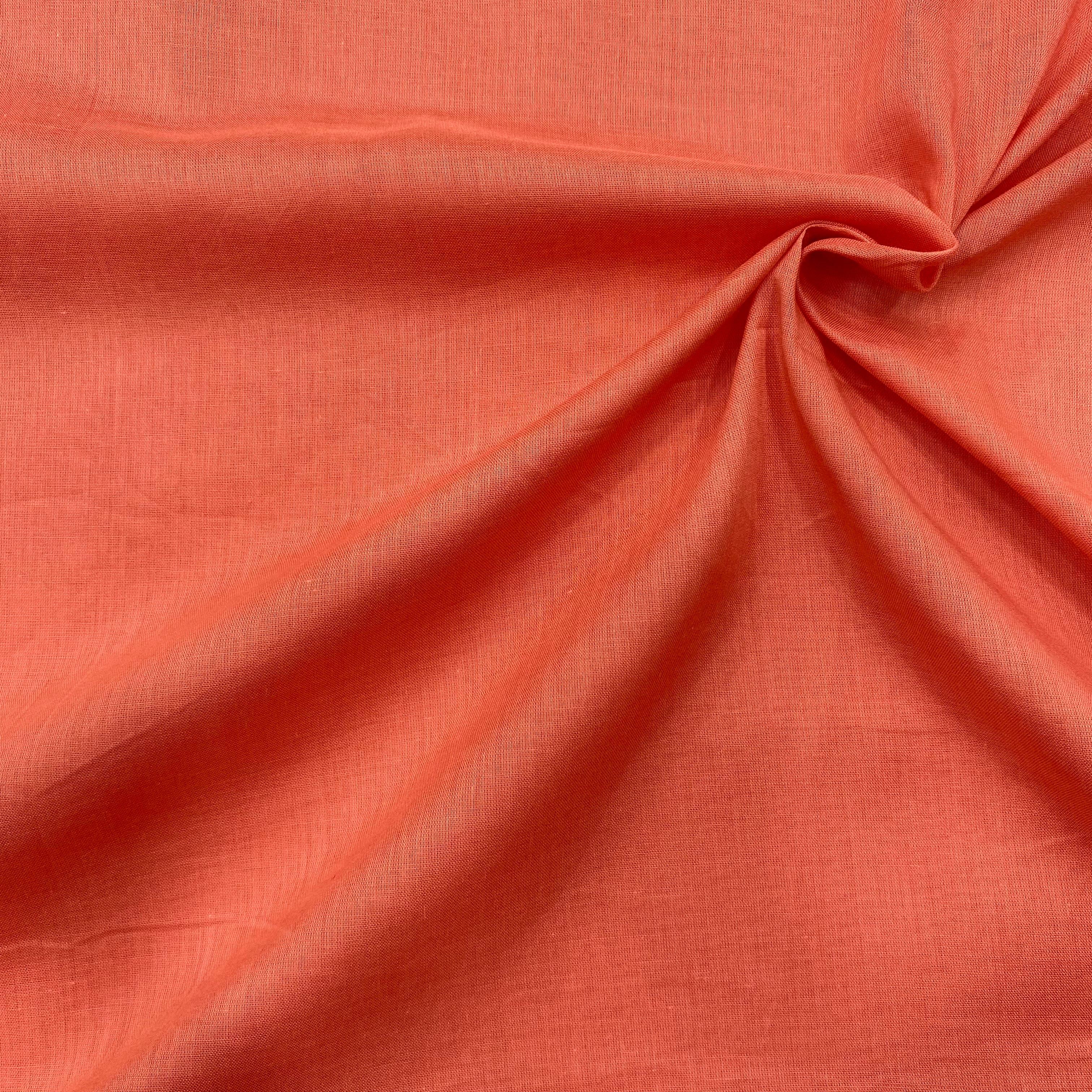 Image of light rust orange mul cotton fabric, soft and breathable, perfect for summer