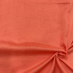 Image of light rust orange mul cotton fabric, soft and breathable, perfect for summer