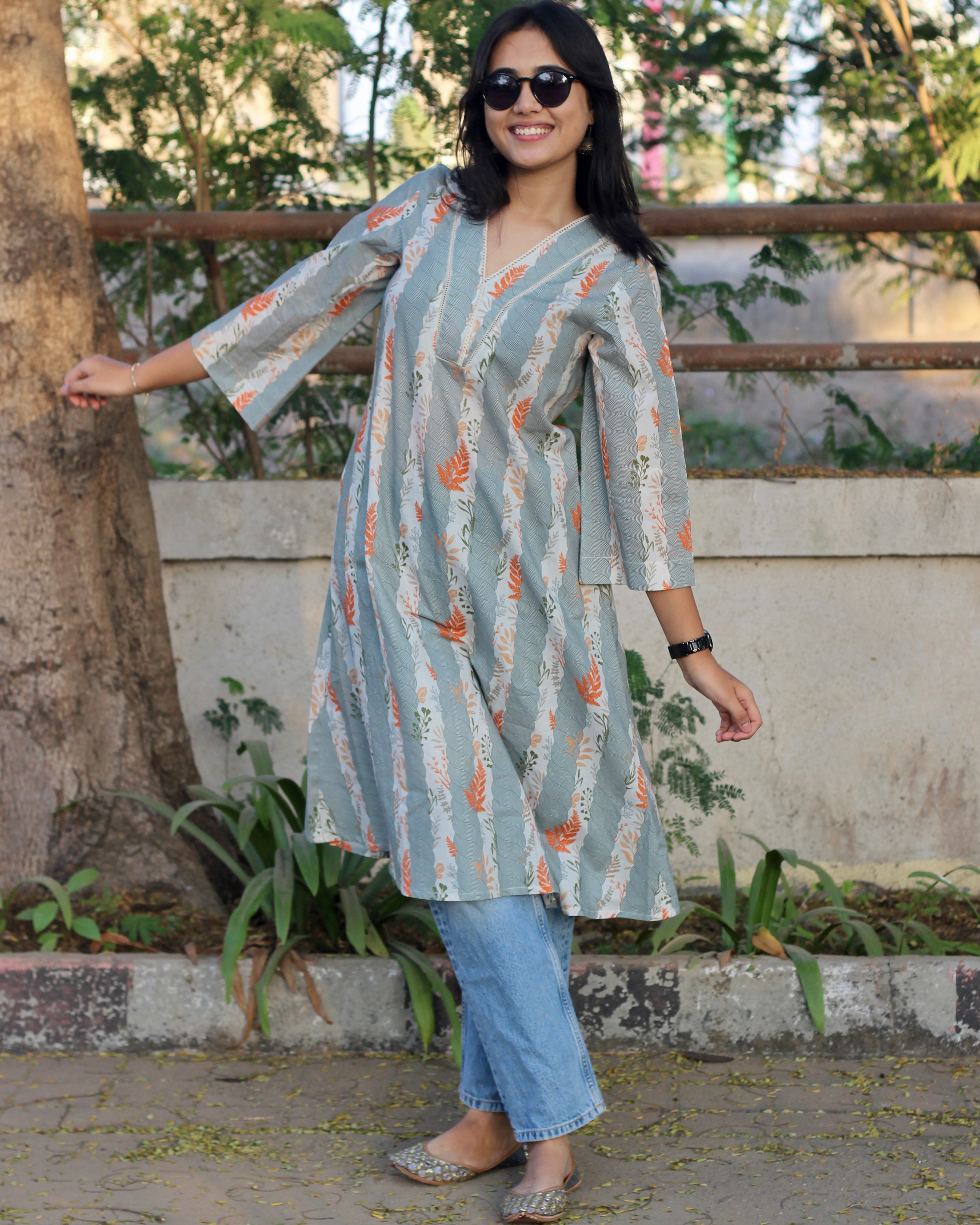 A-line long kurta in premium cotton with green stripe print, orange leaf elements, V-neck lace details, and dual pockets