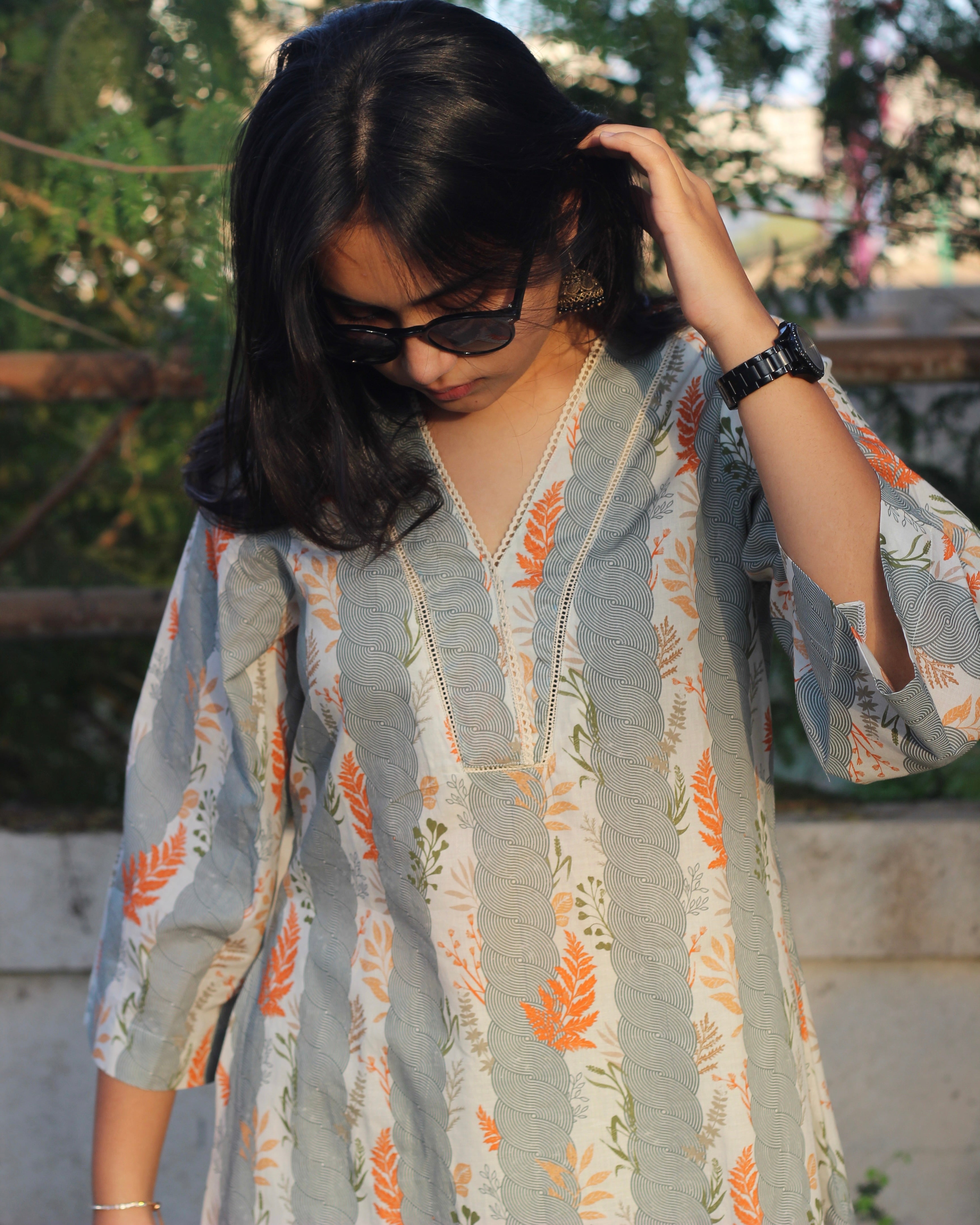 A-line long kurta in premium cotton with green stripe print, orange leaf elements, V-neck lace details, and dual pockets