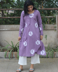 Lavender tie-dye Bandhani cotton kurta with white prints, round neckline, full sleeves, and A-line fit featuring side pockets.