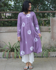 Lavender tie-dye Bandhani cotton kurta with white prints, round neckline, full sleeves, and A-line fit featuring side pockets.