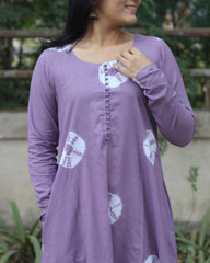 Lavender tie-dye Bandhani cotton kurta with white prints, round neckline, full sleeves, and A-line fit featuring side pockets.