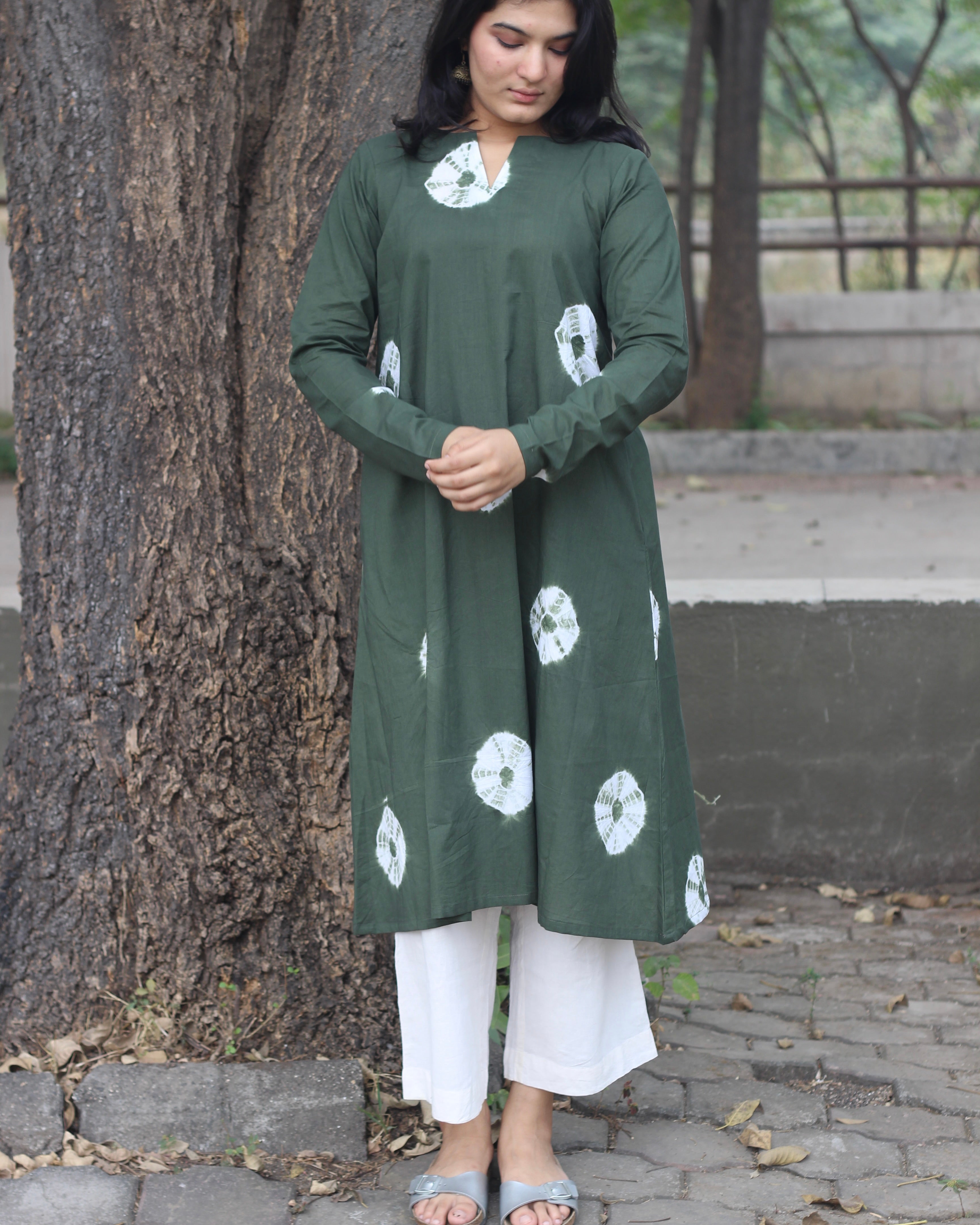 Dark green tye-dye bandhani pure cotton kurta with white bandhani print, long sleeves, V-neck, and pockets.