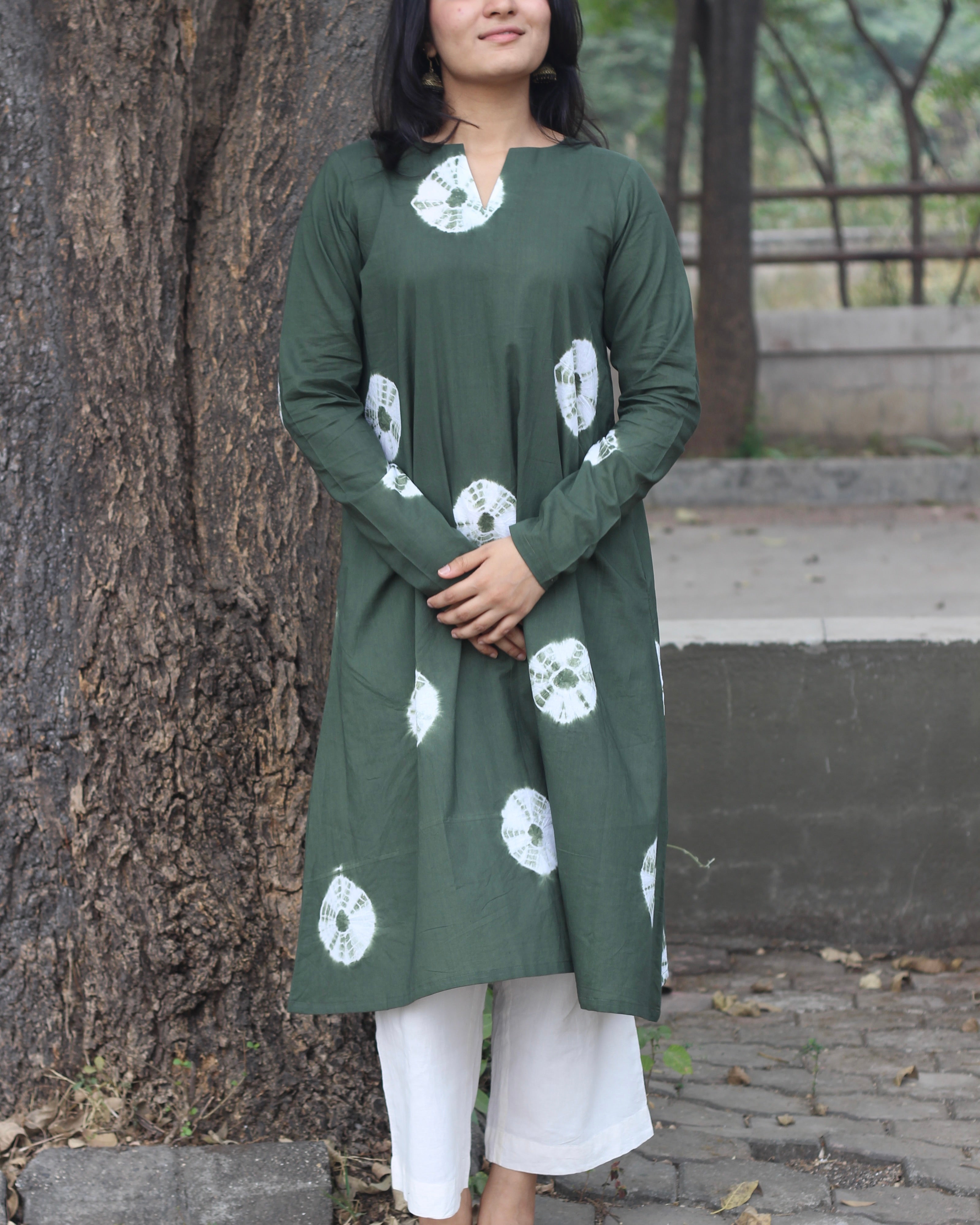 Dark green tye-dye bandhani pure cotton kurta with white bandhani print, long sleeves, V-neck, and pockets.