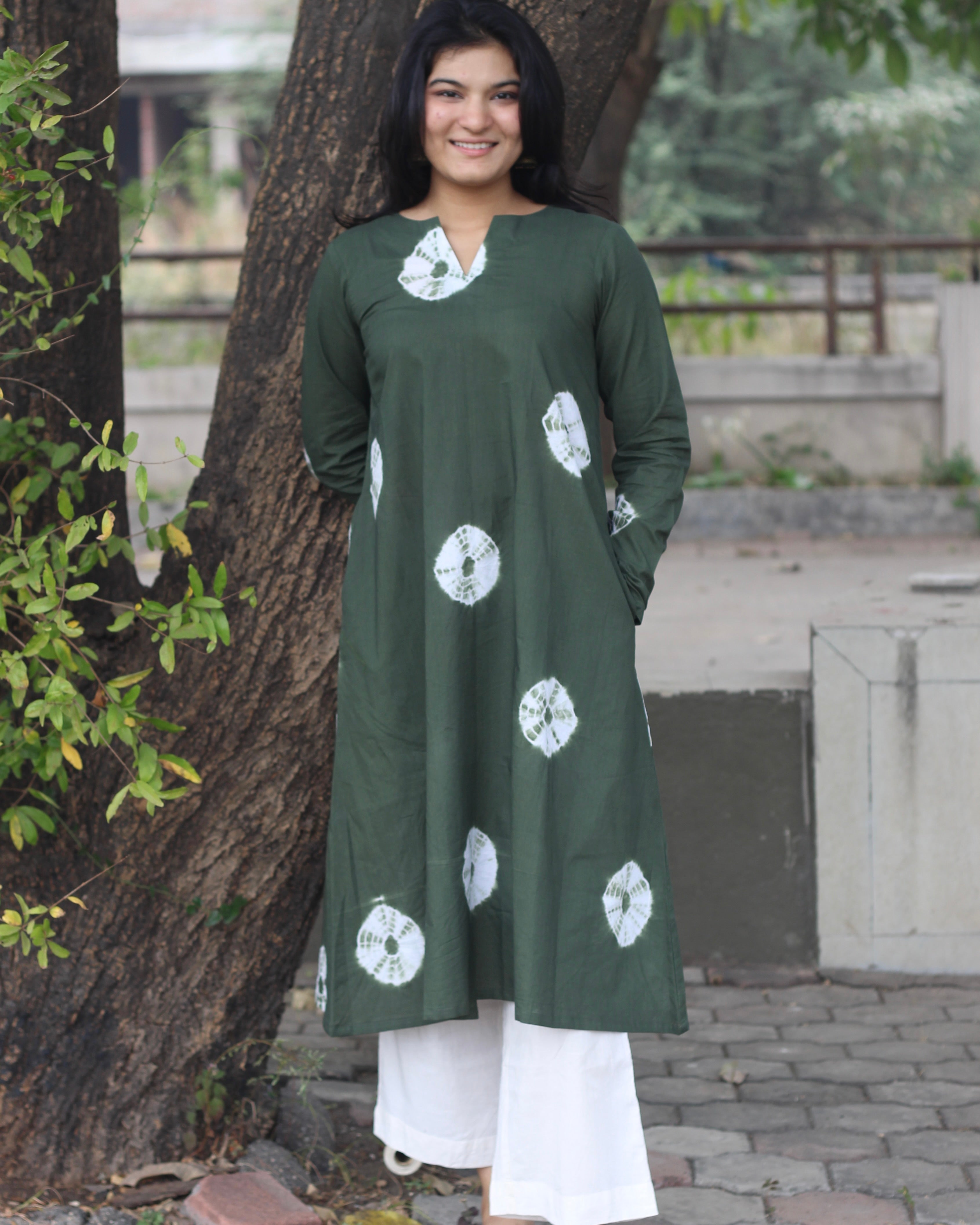 Dark green tye-dye bandhani pure cotton kurta with white bandhani print, long sleeves, V-neck, and pockets.