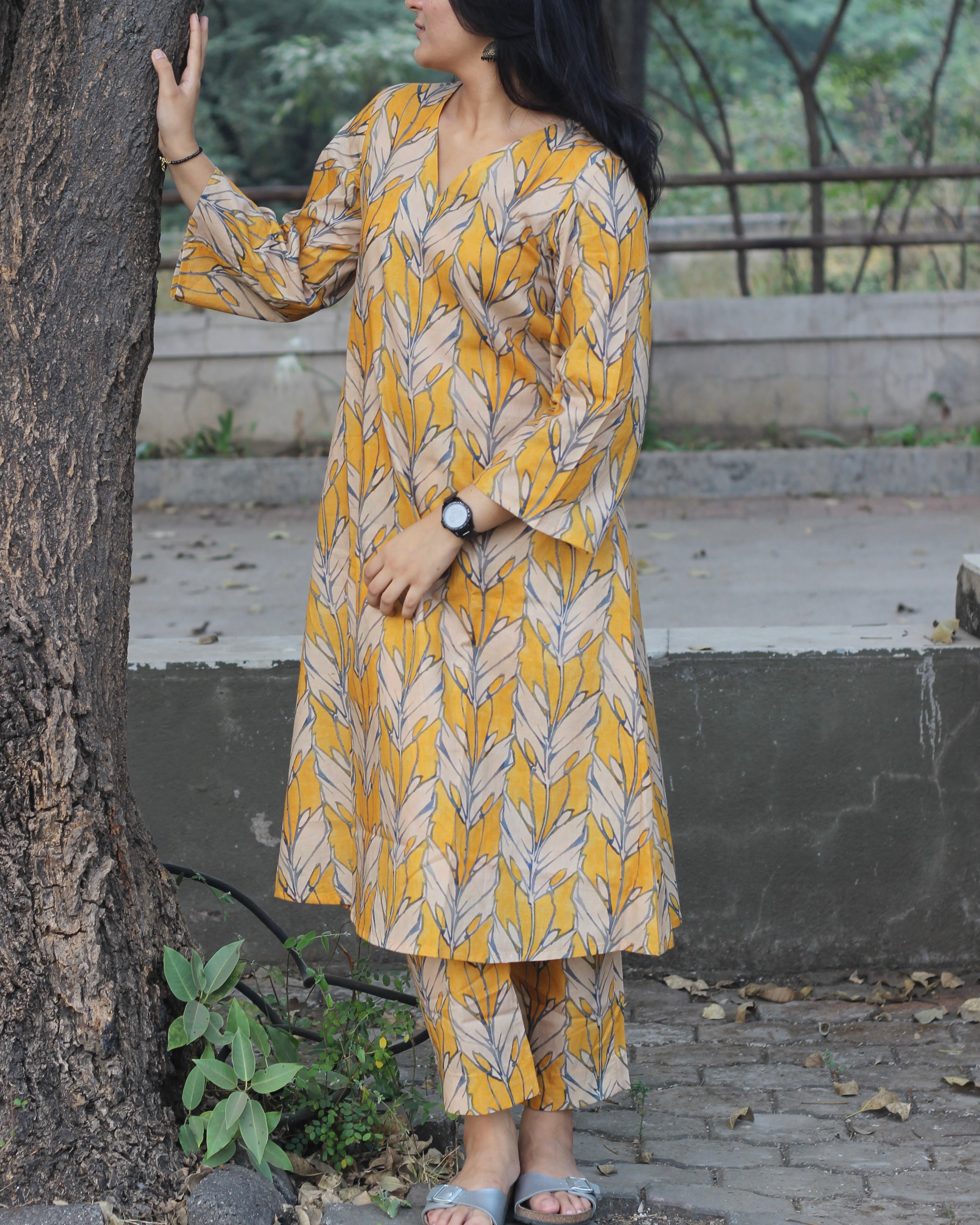 Premium Cotton Kurta and Pant Set in Orange Yellow with White Leaf Print, featuring a V-neckline and pockets.