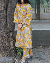 Premium Cotton Kurta and Pant Set in Orange Yellow with White Leaf Print, featuring a V-neckline and pockets.