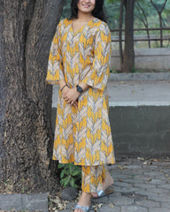 Premium Cotton Kurta and Pant Set in Orange Yellow with White Leaf Print, featuring a V-neckline and pockets.