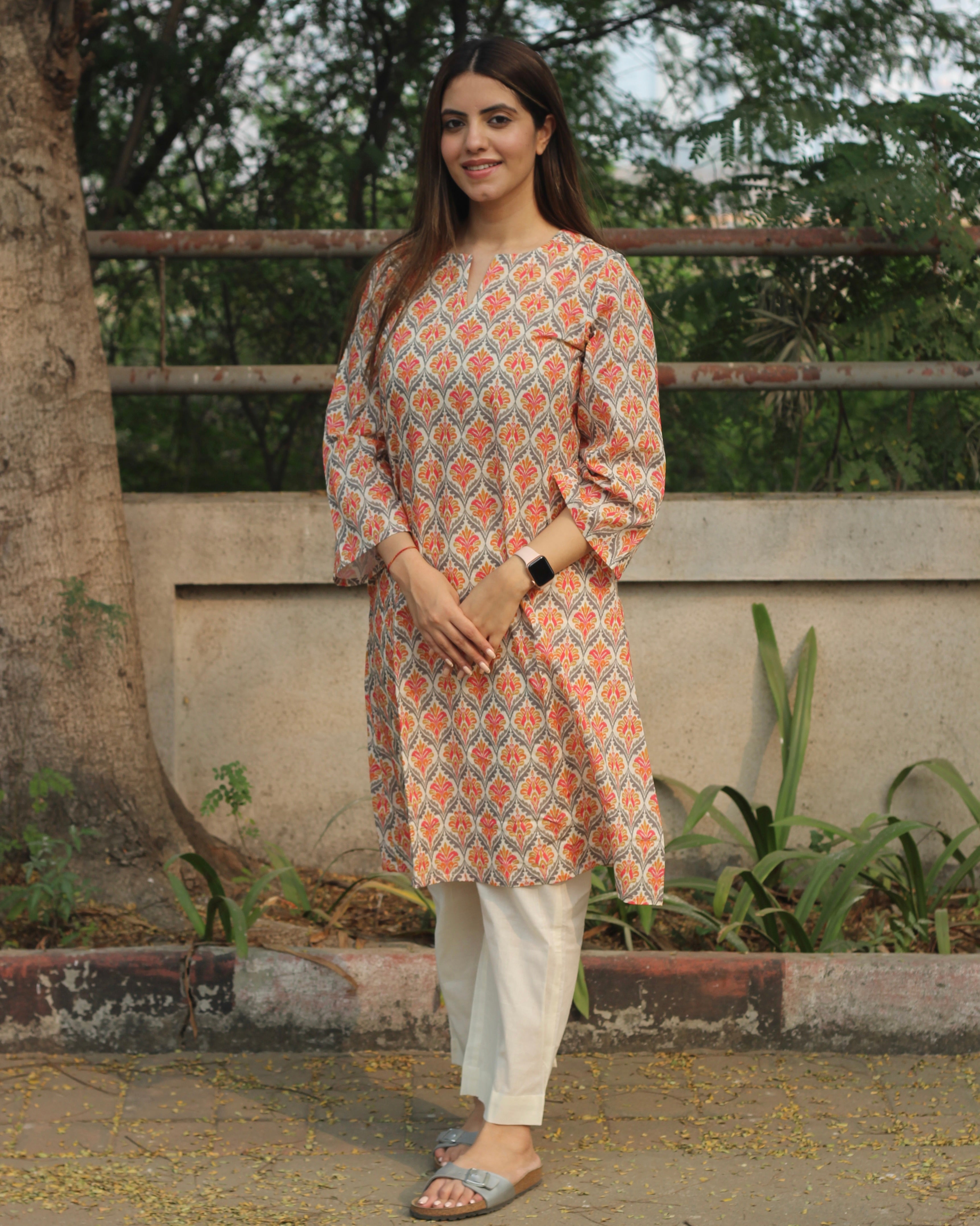 Ikkat Harmony Long Kurta in premium cotton with yellow and pink ikkat print, round neck with V-cut, and side pockets.