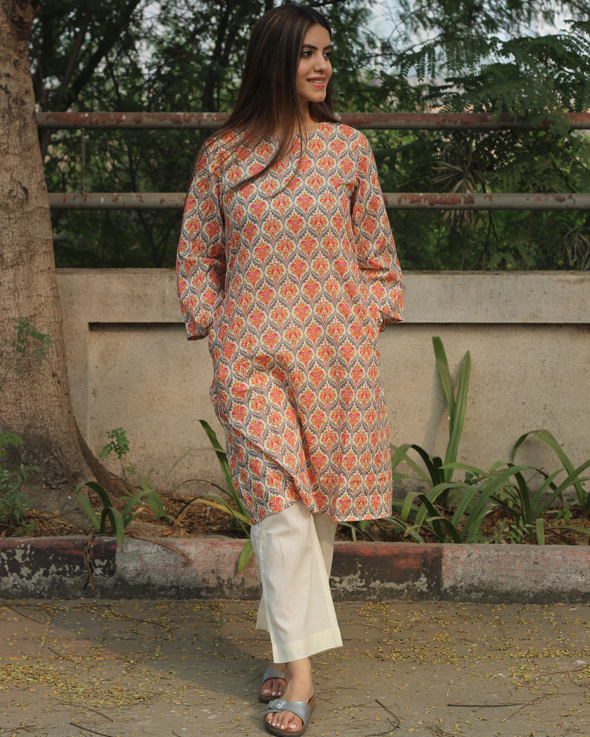 Ikkat Harmony Long Kurta in premium cotton with yellow and pink ikkat print, round neck with V-cut, and side pockets.