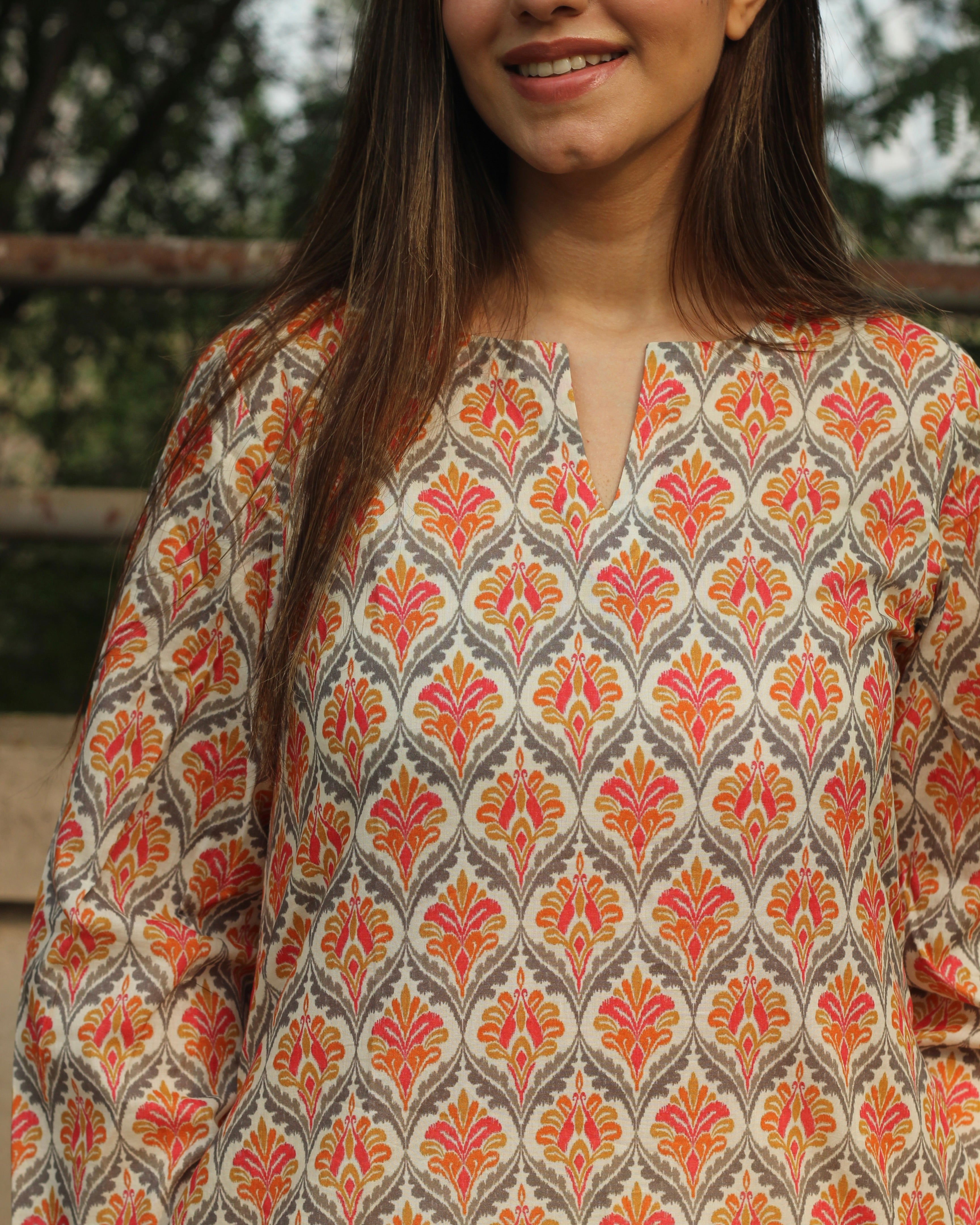 Ikkat Harmony Long Kurta in premium cotton with yellow and pink ikkat print, round neck with V-cut, and side pockets.